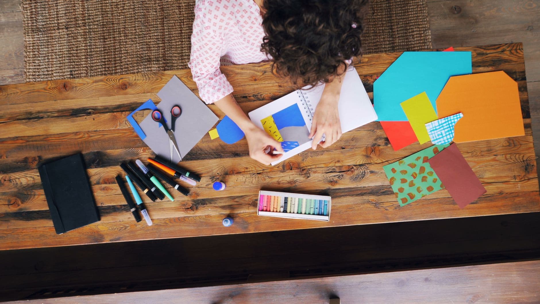 An overhead view of a crafting station with art supplies