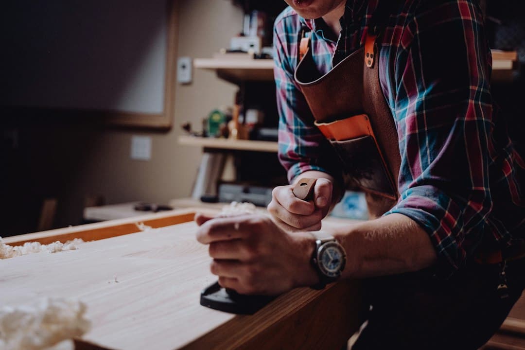 A man working on a piece of wood in a workshop