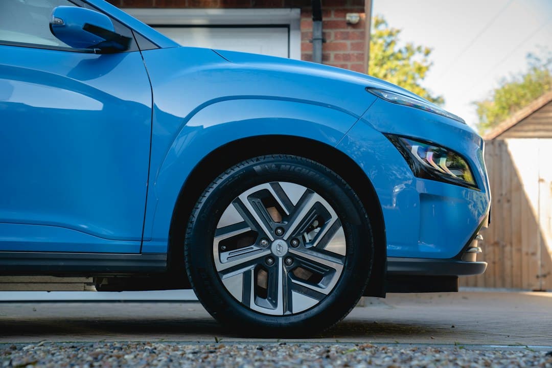 A blue car parked on a driveway