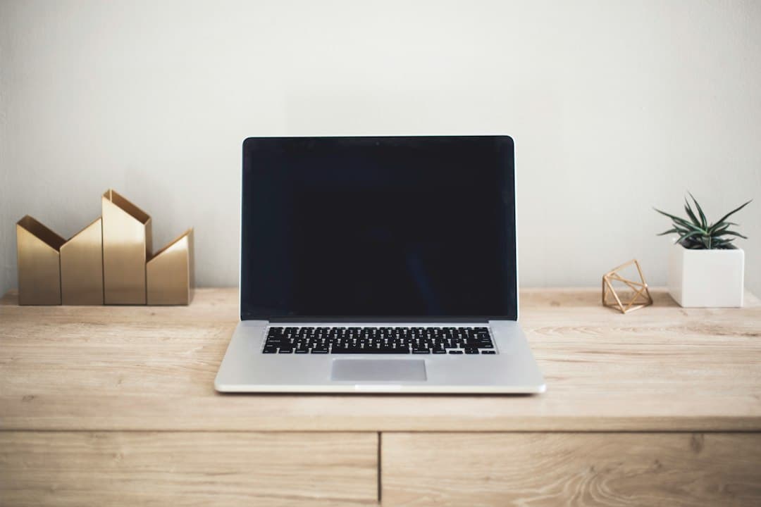 A laptop open on a wooden table