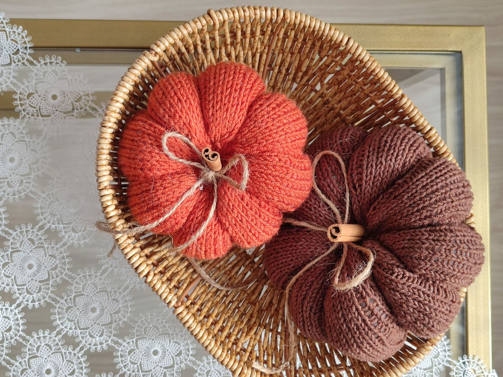 Knit pumpkins in autumn colors in a wicker basket