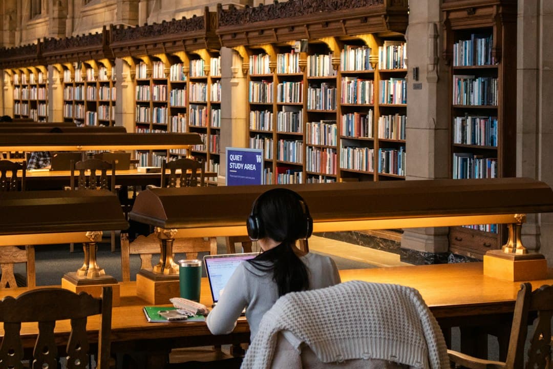 A student studying at a library table with books