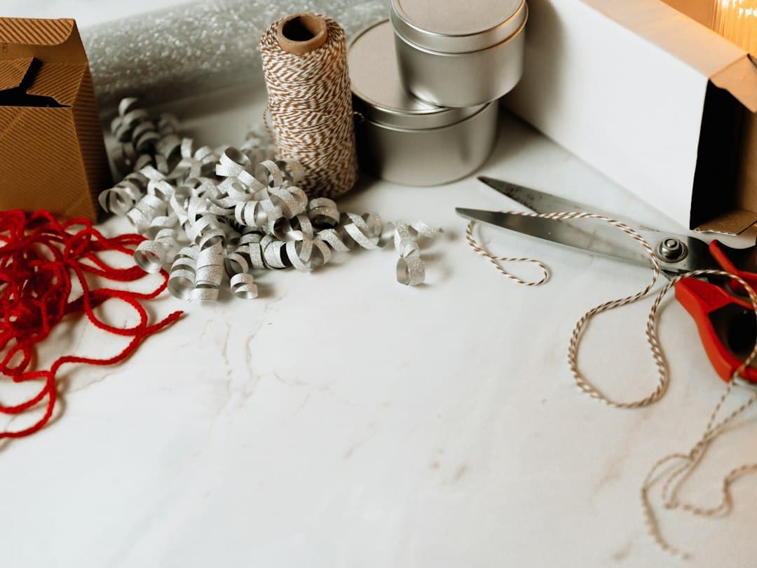 Scissors and a sewing needle on a craft table