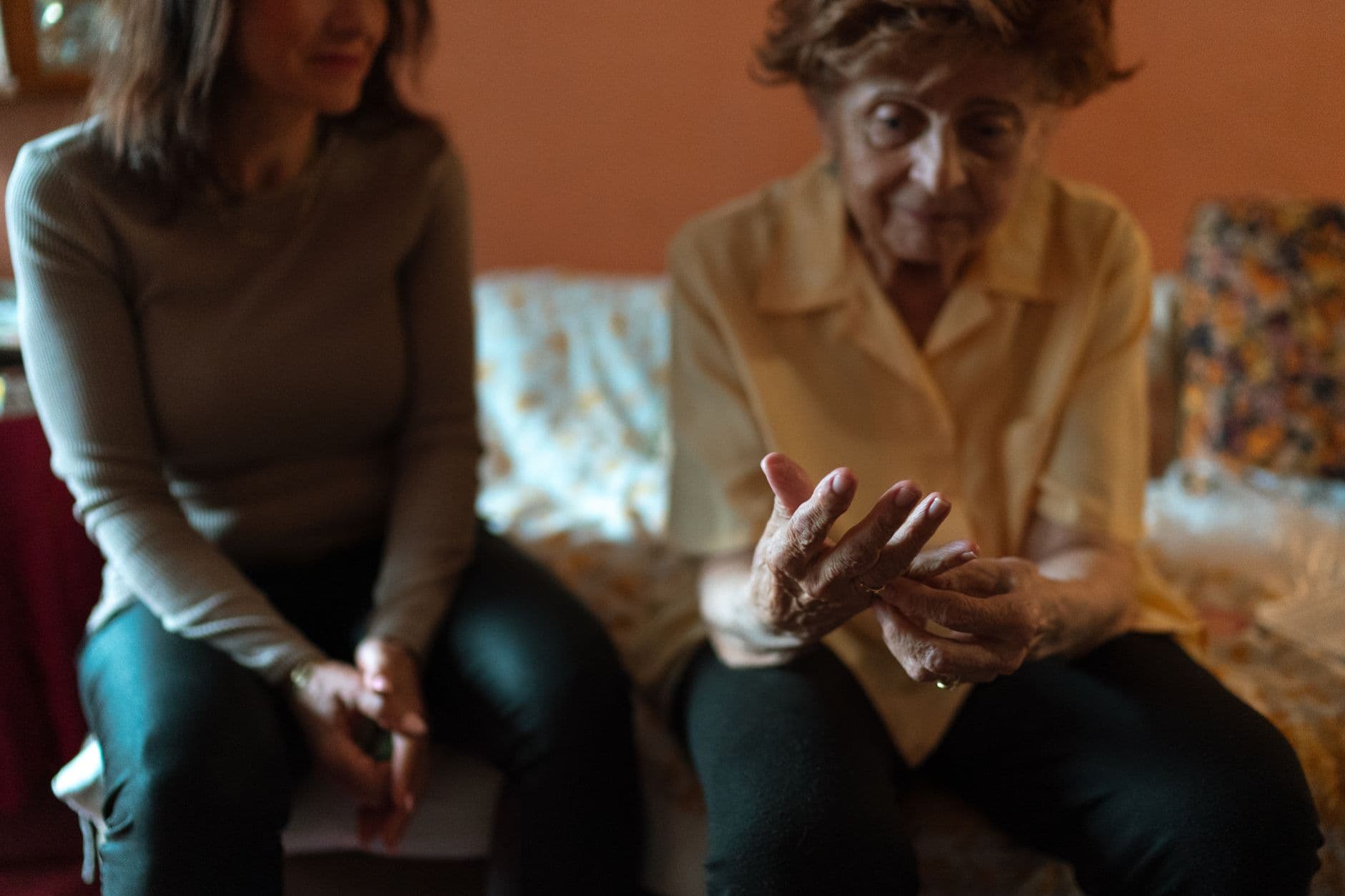An older woman and her companion sharing a moment on the couch