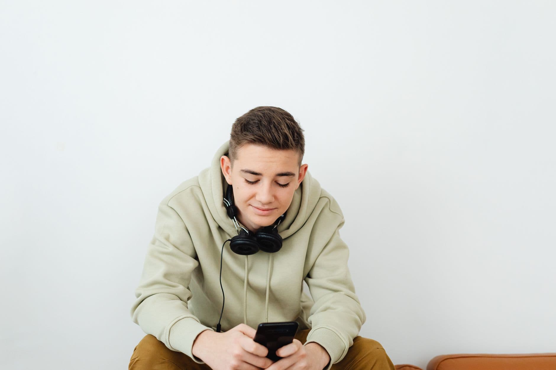 A young person wearing headphones and listening to music