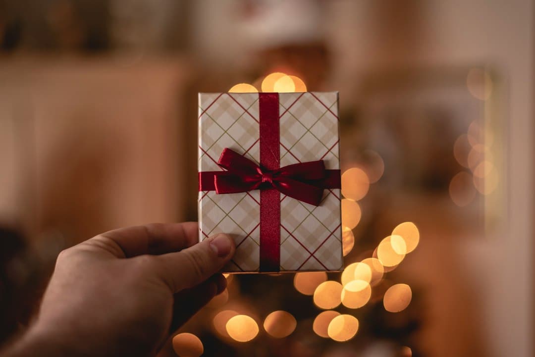 A person holding a white gift card