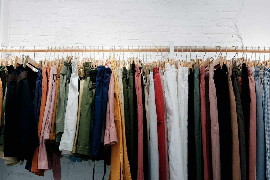 Colorful clothes hanging on a wooden wall rack