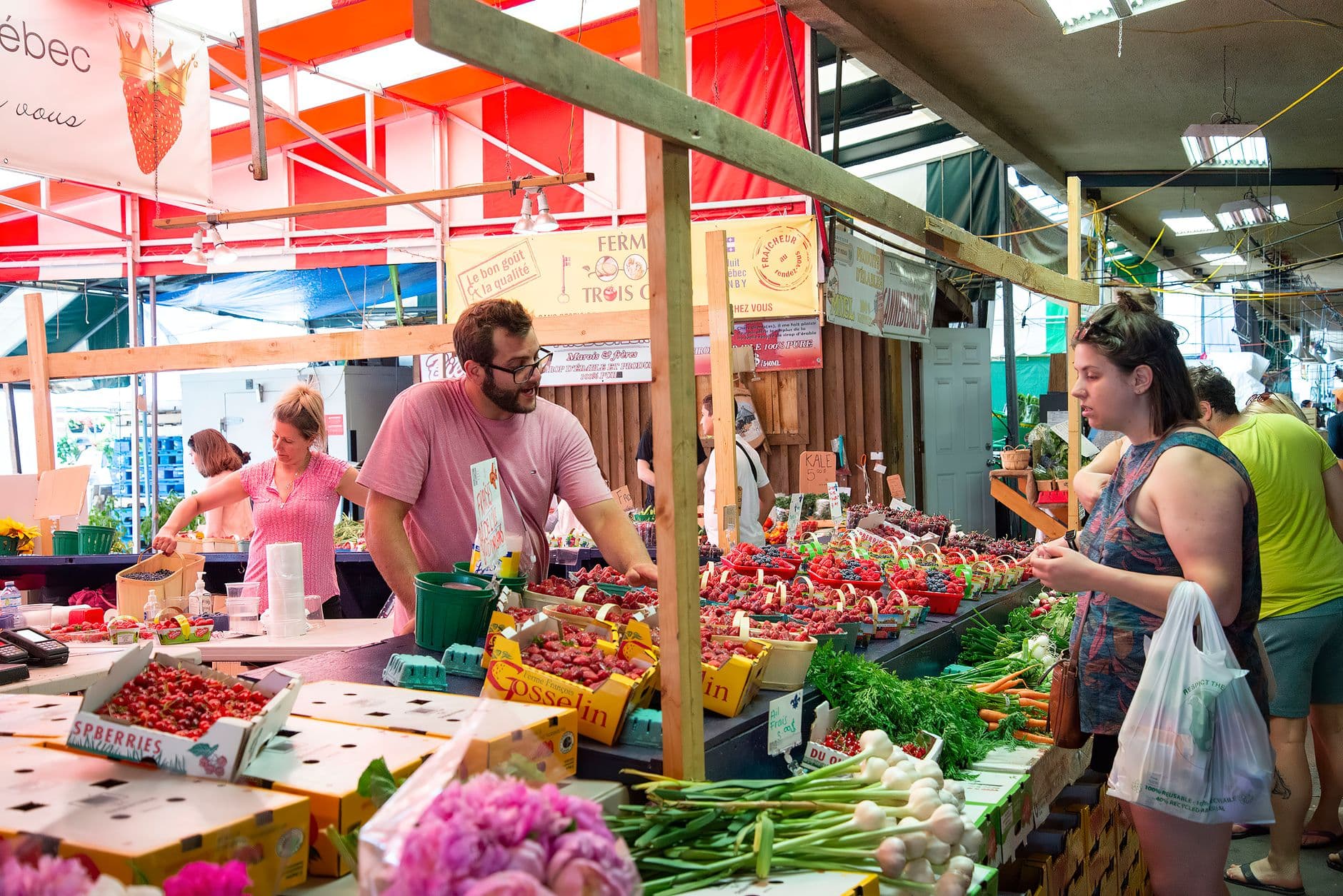 A busy farmers market with fresh fruits and vegetables