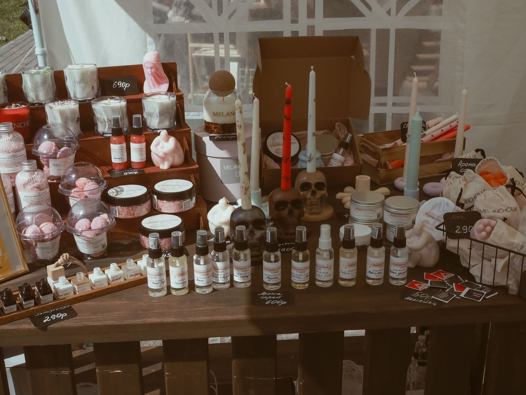 Handcrafted candles and skincare items on a market stall